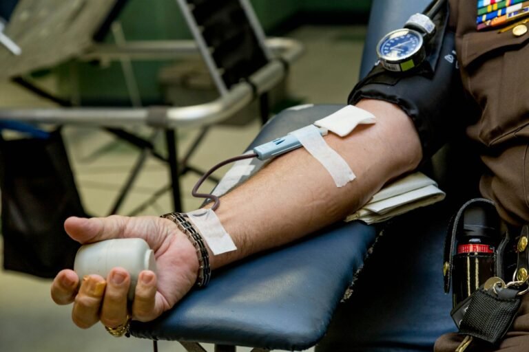 A person getting his blood pressure check using a blood pressure monitor